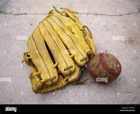 Photo of a baseball gloves and an old baseball Stock Photo - Alamy