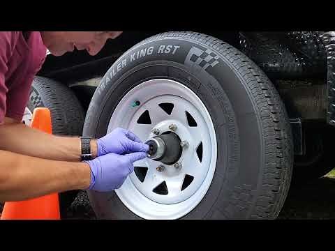 How to repack trailer wheel bearings with grease on a Sure-Trac trailer.