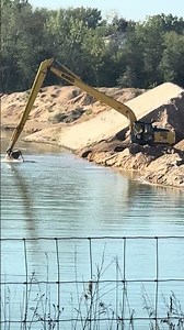 Large excavator digging in lake for sand/excavation/heavy equipment/sand pit/deep water