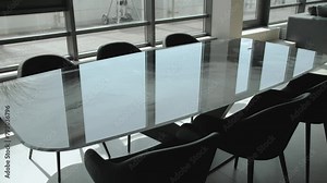 Conference room in a building with glass table, chairs, and window view Stock Video