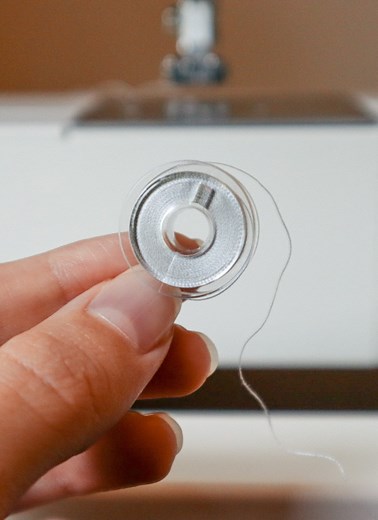 How to Wind and Insert a Bobbin into a Singer Tradition Sewing Machine - Hailey Stitches