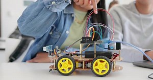 Robotics, education and hands of children at school learning about coding
