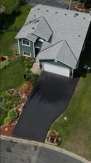 Asphalt paving a driveway. Making it look easy.
