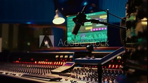 Music recording studio control room with pre amp knobs used for volume level adjustments. Stereo equipment as equalizer, mixer, switchers and sliders are operated in post production.