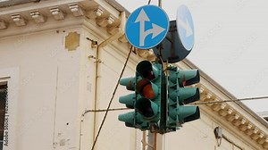 Urban Traffic Signal with Dual Arrow Signs and Classical Architecture Background