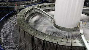Textile industry - yarn spools on spinning machine in a factory
