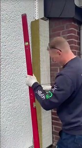 the process of installing colorful styrofoam blocks on the outer walls of the building #construction