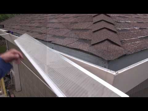 Installing gutter guards on an asphalt shingle roof