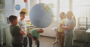 Environmental Science Lesson: Primary School Children Talking, Looking at Earth Model. Talented Kids Learning Geography, Ecology and Renewable Energy Resources in Classroom. Interactive STEM Education