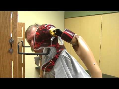 Bilateral Arm Amputee Puts on Prosthesis - Uses Dressing Tree