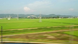 looking through window from moving train, Japanese country side