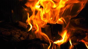 Burning Fire In The Fireplace. Warmth and home comfort. Flame of a country house. Firewood is burning in the hearth. Detailed fire background. 4K