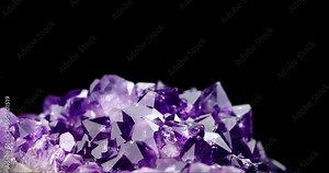dark crystal amethyst druse 360° rotation in 4k. macro detail texture background. close-up raw rough unpolished semi-precious gemstone