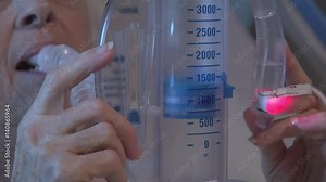 Patient using an incentive spirometer or volume exerciser