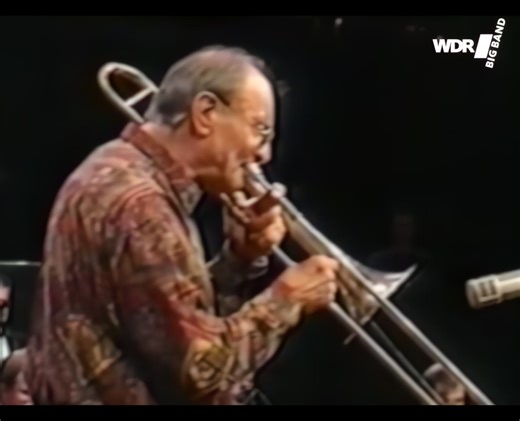Our second "birthday boy" of the day is the legendary, German trombone player Albert Mangelsdorff! Here's a clip of us playing with Albert, back in 1997, Bill Dobbins arrangement of the Indonesian children's song "Burungkaka". It features Albert Mangelsdorff on trombone and Frank Chastenier on piano, with a special appearance from our trombone section to boot. Recorded live in the Kölner Philharmonie, conducted by Bill Dobbins. ------------------ Unser zweites „Geburtstagskind“ des Tages ist der
