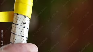 regrip tennis racquet. regripping a tennis racquet before a match. replacing a racket grip