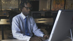 Man working on computer in an office at night - Free Stock Video