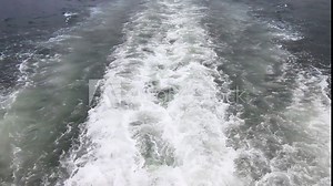 Ship wake on the water behind the boat. Ocean wake