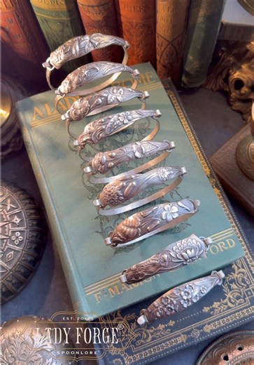 Let’s make a set of sterling silver bangles from 138 year old sterling spoons ✨ These are 9 of the 18 gorgeous botanical designs found within George Shiebler’s 1887 Flora set. If ever there was a spoon destined to be a spoon bangle, it was the 1887 Flora. Their wide handles with ultra smooth backs pair perfectly with my hand-fabricated sterling silver bangle bands. Each custom made to fit your wrist measurements specifically. All nine of the Flora bangles are available now, and as always, my tre