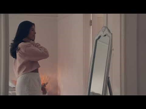 Stock Footage - Young Woman Looking At Reflection In Mirror