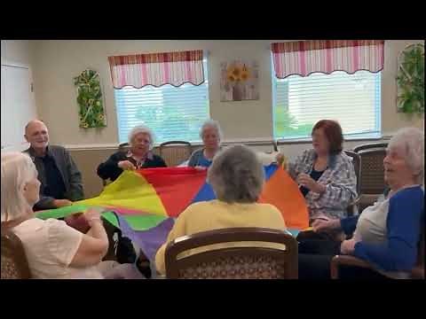 Parachute Ball Toss exercises with our memory care residents 4/6/23