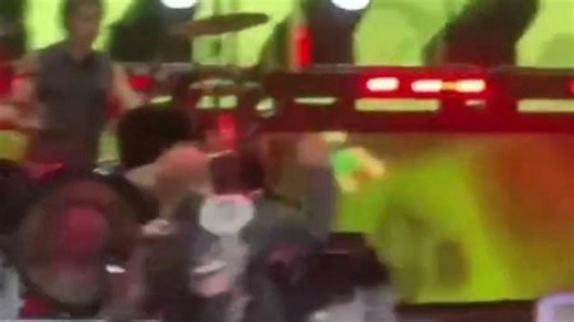 Axl Rose flips out on stage, throws mic at drummer then storms off