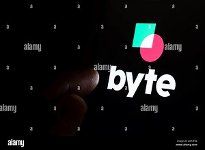 Byte app logo on the dark touch screen and finger is pointing at it. Byte new social media platform competitor to TikTok Stock Photo - Alamy