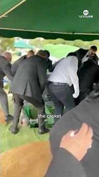 Pallbearers fall into grave at burial