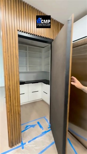 Custom Pantry. Where? 👀 Hidden pantries are becoming one of the hottest design trends of 2025 and it’s easy to see why. Tucked seamlessly behind textured walls, these sleek, camouflaged pantry doors create a clean, uninterrupted look while keeping storage beautifully concealed. | CMP-Construction & Metal Buildings