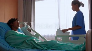 Young asian nurse care and assistance with patient man at hospital or clinic, nurse carefully tending to male patient, medical and insurance.