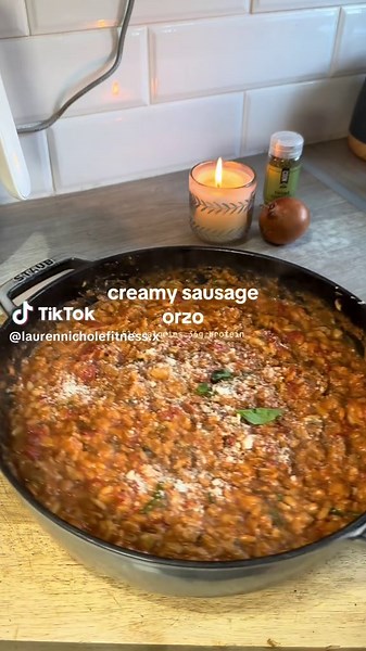 creamy sausage orzo w/ truffle cheddar 🧄 516 calories • 36g protein • 59g carbs • 14g fat Ingredients: (serves 4) 8 low fat pork sausages 240g orzo (uncooked weight) 1 tin cherry tomatoes 1 tin chopped tomatoes 100ml single cream 2 vegetable stock cubes 1 large white onion 4-6 garlic cloves 2 handfuls button mushrooms 10g Parmesan 60g truffle/normal cheddar Bunch fresh basil Seasonings; salt, pepper, thyme, sage, oregano 1. Dice onion and fry in some olive oil, once softened add in your garlic 