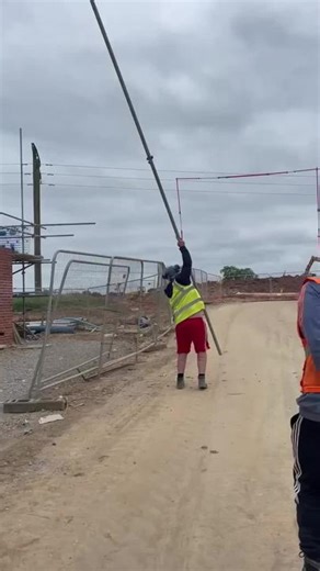 Construction Site Mishap: Worker Falls While Adjusting Pole