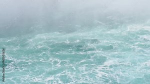 Niagara Falls falling mist over turquoise water and white rapids in Niagara River