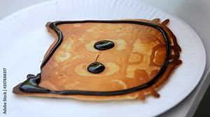 Baked pancake made on food 3d printer and poured chocolate. 3D printer for liquid dough. 3D printer printing pancakes with liquid dough different shapes close-up. Modern additive food technologies