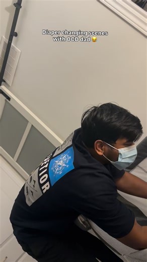 Ramya sri on Instagram: "My husband changing the diaper with a mask… sir, it’s just baby poop 😭😂 . . . . Daddy duties, ocd dad"