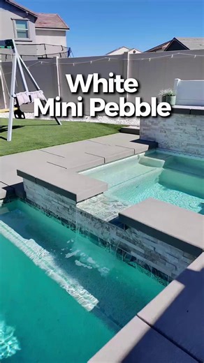 If you’re curious how White Mini Pebble looks once a pool is filled and catching natural light, this video gives you a true look at its clean, bright, modern feel. From shallow steps to deeper water, the tone shifts beautifully, giving you clarity, sparkle, and a timeless finish that works with any backyard style ✨ Thinking about White Mini Pebble for your own build? We’re here to help you compare all your options. #WhiteMiniPebble #PoolDesign #BackyardOasis #ModernPools #PoolInspiration #Outdoo