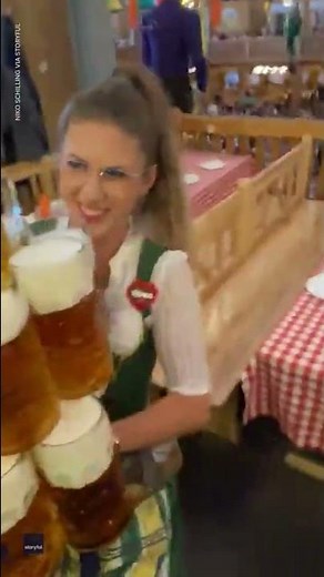 Oktoberfest waitress carrying massive stack of beers wows onlookers | USA TODAY #Shorts