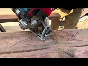 Cutting out stairs on 2x12 pressure treated stringers on deck remodel.