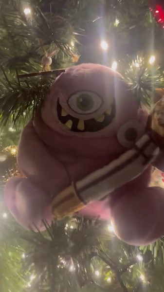 Ollie loves TOMY plush toys on Christmas tree