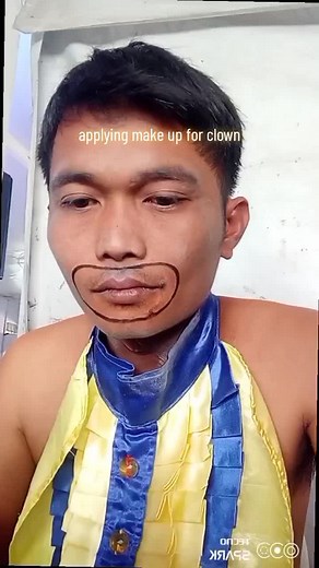 applying make up for clown