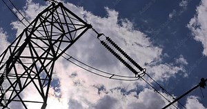 Power line tower with clouds