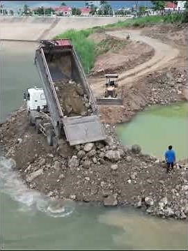 Great Teamwork of Dump Trucks And Komatsu Dozer Working Near Deep Water