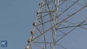 10K views · 34 shares | Putting your life on the line... literally! World's first live-wire operation on a 1,100-kV direct-current (DC) transmission line is completed in Anhui, E China by Chinese workers | China Xinhua Sci-Tech | Facebook