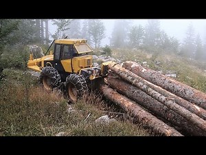 Skidder Ecotrac skidding big logs on rocky Mountain