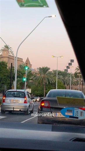The evening settles gently over Palma de Mallorca as we drive past the harbor, the golden sun sinking slowly behind the masts of the boats. The air carries the soft scent of the sea, mingling with the echoes of footsteps along the Paseo Marítimo. The water glows with a warm reflection, painting the horizon in shades of amber and rose. It feels as if time slows down, as though the city itself wishes to savor the last light of day. Here, history and culture whisper through every corner — from the 