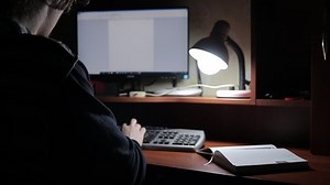 man works at home at the computer