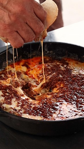 HOW TO MAKE CHORIQUESO! This melty, cheesy recipe is also called queso fundido and makes a great game day meal. It’s so easy to make with only TWO ingredients: chorizo and queso Oaxaca! Start by cooking the chorizo in a pan until fully cooked, then reserve a little on the side for topping the dish. Add the grated cheese to the chorizo in the pan and allow it to melt. (You can also just toss this in the oven for the same result.) Top the dish with the reserved chorizo or your favorite toppings, l