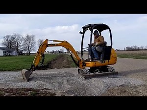 Mini Excavator Digging A Driveway
