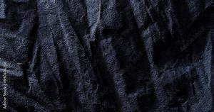 Black crumpled texture surface. Seamless loop. Used as a background and texture.