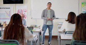 Boy, presentation and speech in classroom at high school with notes, opinion and project for assessment. Teacher, writing and student in oral exam for progress, language or smile for public speaking